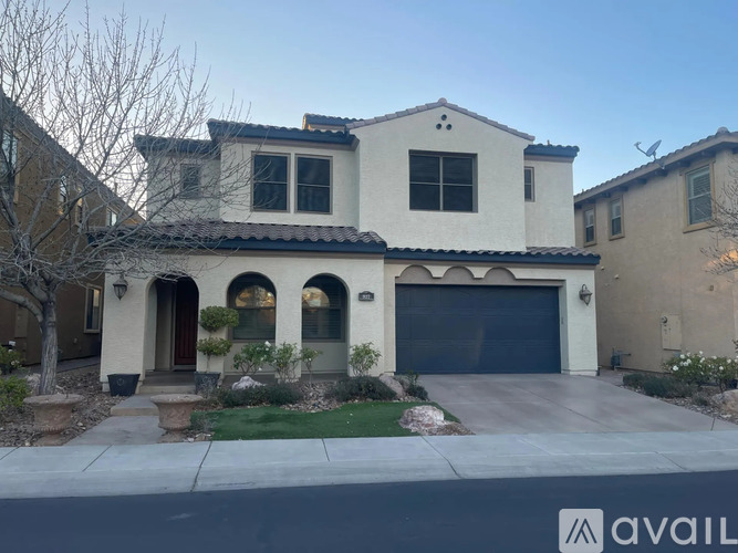 A house with a garage and a driveway in front.