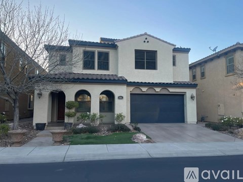 A house with a garage and a driveway in front.