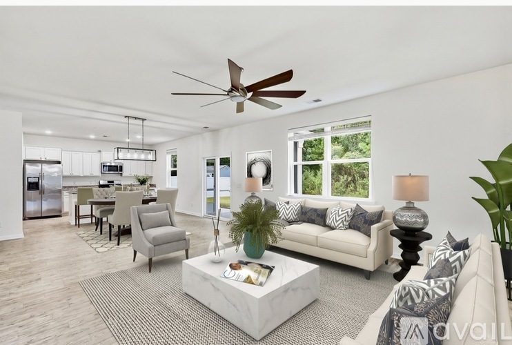 A modern living room with a white sofa and a coffee table.