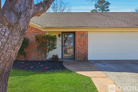 A house with a brown roof and a white garage door.
