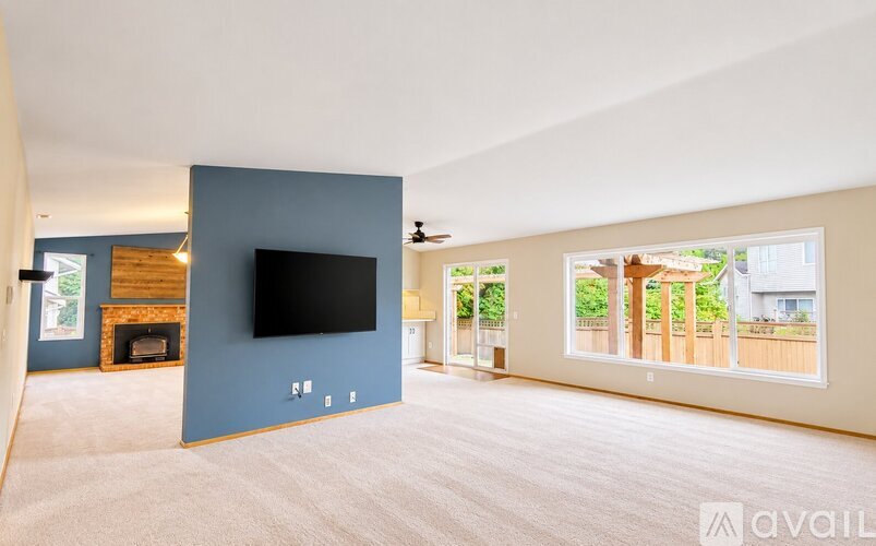 A living room with a fireplace and a flat screen TV.