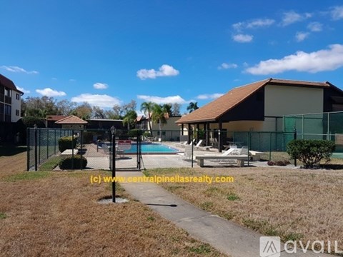 A sunny day at a residential area with a pool and houses.