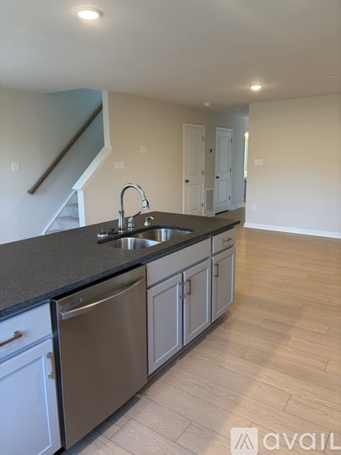 A kitchen with a stainless steel dishwasher and a sink.