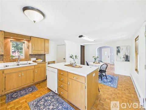 A kitchen with wooden cabinets and a white countertop.