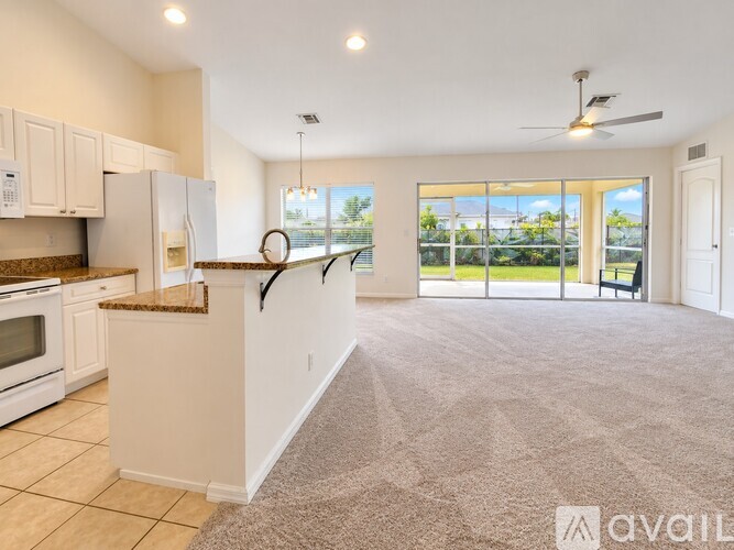 A spacious kitchen with a refrigerator, microwave, and oven.