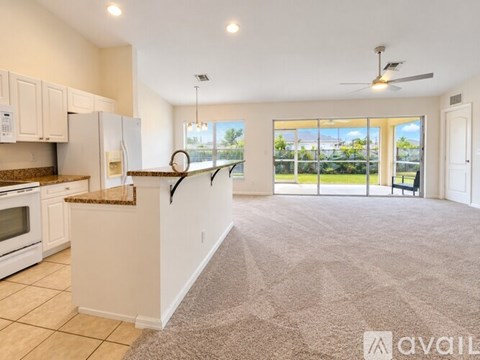 A spacious kitchen with a refrigerator, microwave, and oven.