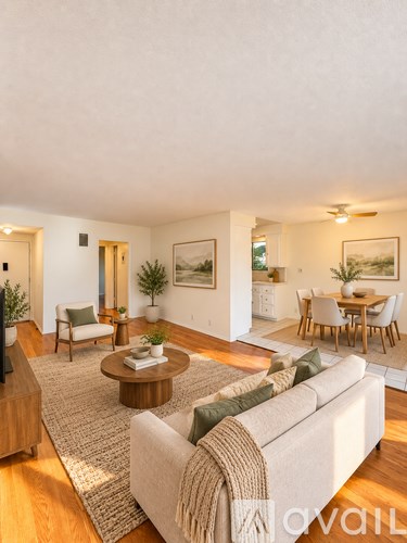 A living room with a couch, chairs, and a coffee table.