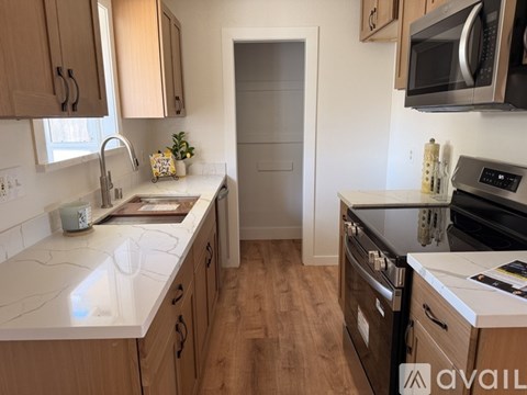A kitchen with wooden cabinets and a white countertop.