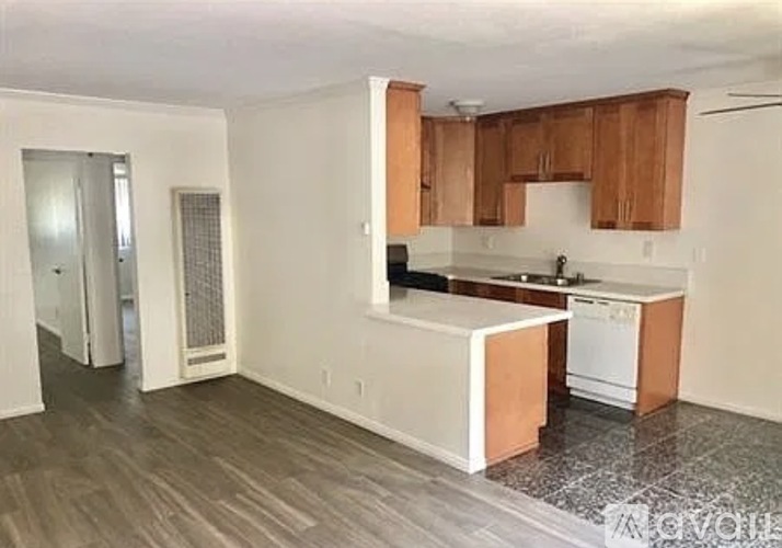 A kitchen with wooden cabinets and a white island.