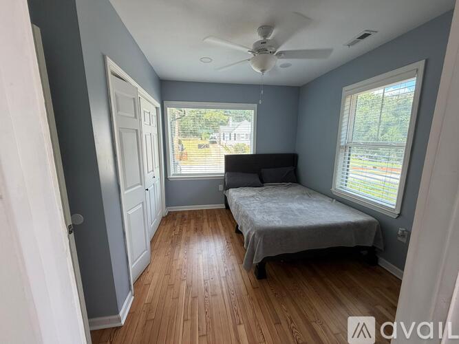 A bedroom with a bed and a window.