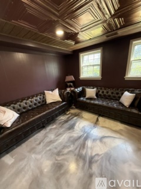 A bedroom with a large bed and a window.