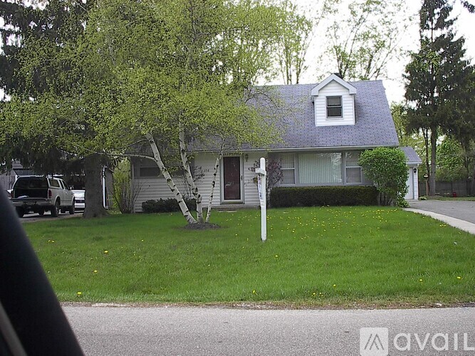 A house with a tree in front of it.