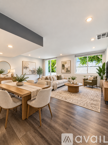A modern living room with a dining table and chairs.