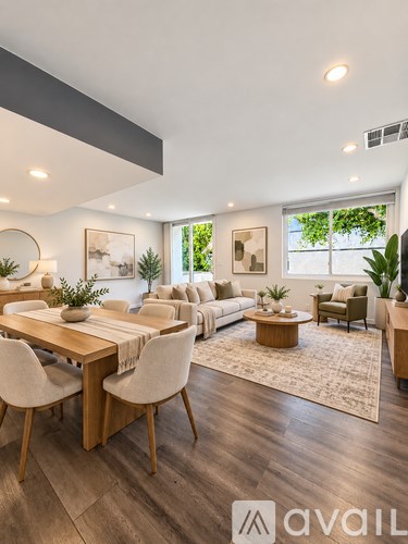 A modern living room with a dining table and chairs.