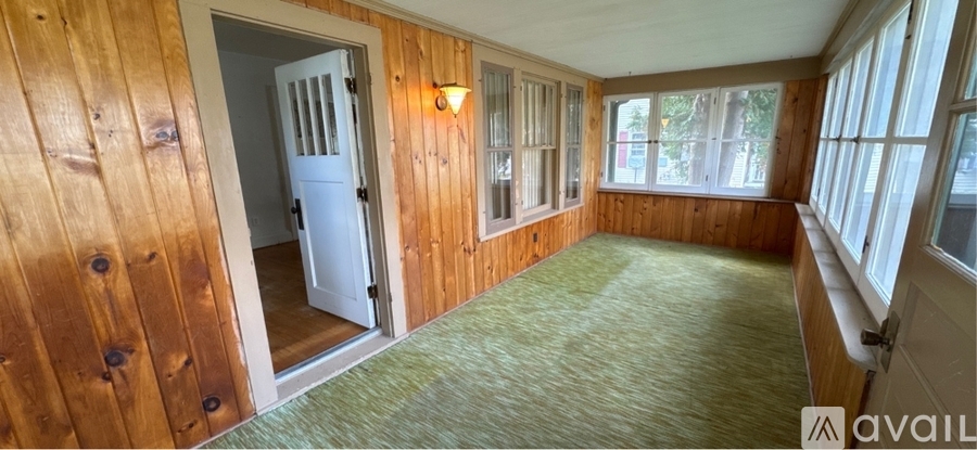 A room with wooden walls and a carpeted floor.