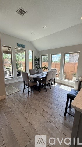 A dining room with a table and chairs is available for rent.