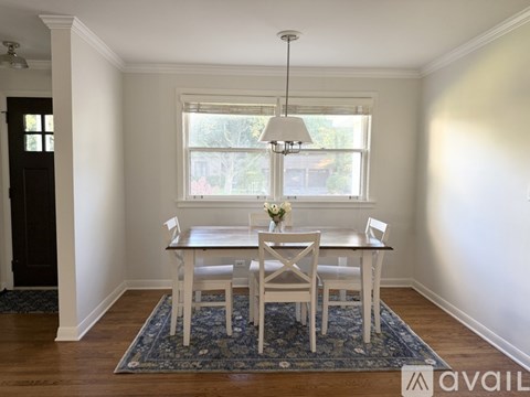 A dining room with a table set for two.
