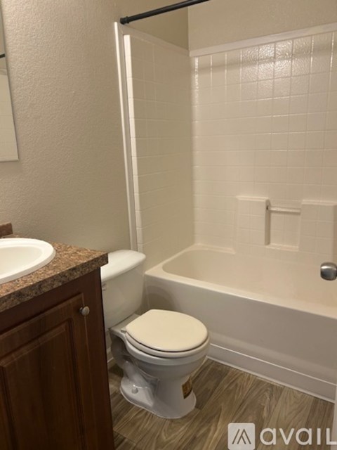 A white toilet sits next to a sink in a bathroom.