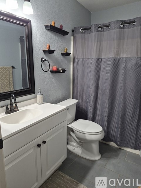 A bathroom with a white toilet and a white sink.