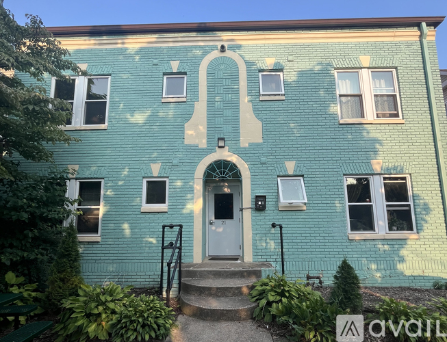 A blue house with a white door and windows.
