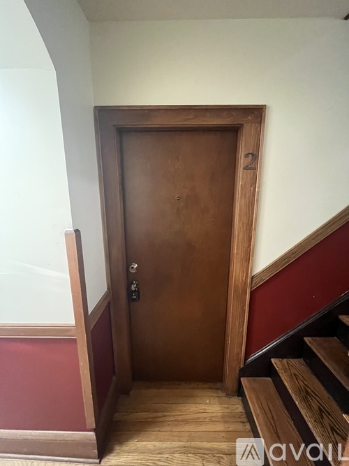 A wooden door with a number 2 on it.