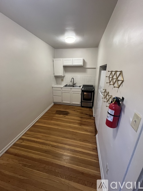 A kitchen with a red fire extinguisher on the wall.