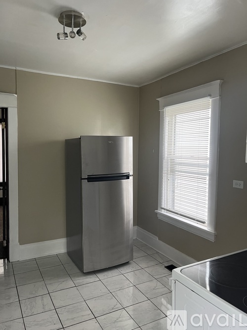 A kitchen with a stainless steel refrigerator and a dishwasher.