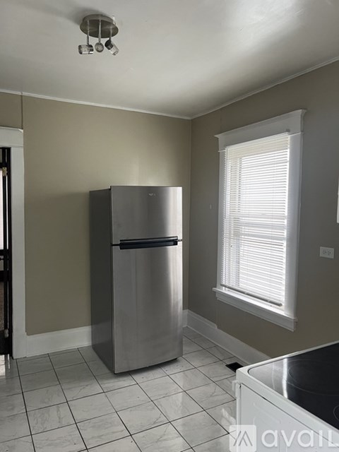 A kitchen with a stainless steel refrigerator and a dishwasher.