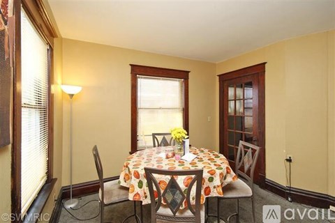 A dining room with a table set for two.