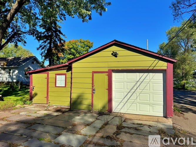 A two-car garage with a yellow and red exterior.