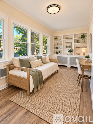 A bedroom with a bed, a chair, and a rug.