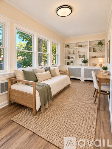 A bedroom with a bed, a chair, and a rug.