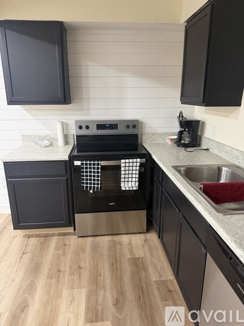 A kitchen with a black oven and a black microwave.