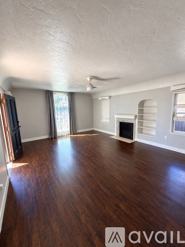 A room with wooden floors and a fireplace.