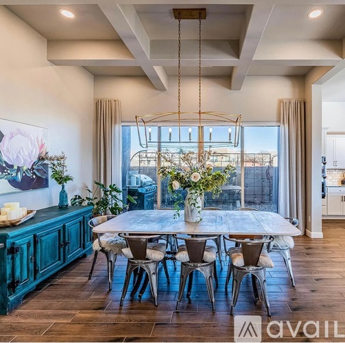 A dining room with a large table and chairs.