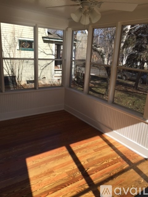 A room with wooden floors and a ceiling fan.