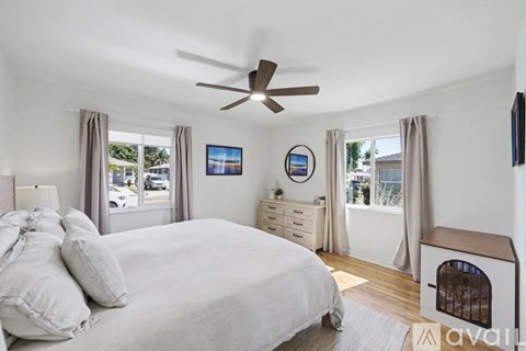 A bedroom with a large bed and a dog house.