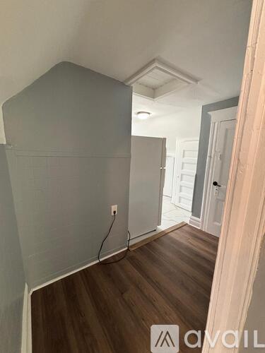 A room with a wooden floor and white walls.