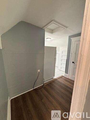 A room with a wooden floor and white walls.