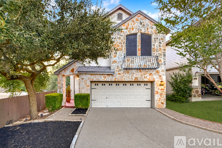 A house with a stone facade and a white garage door.