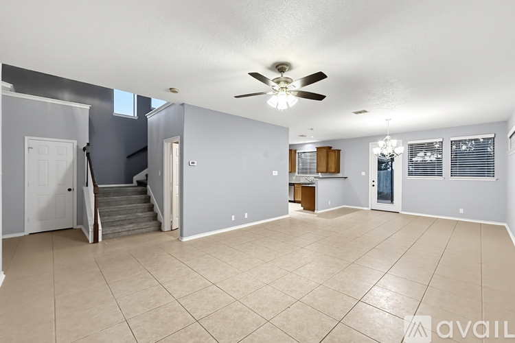 A spacious living room with a staircase leading to the upper floor.