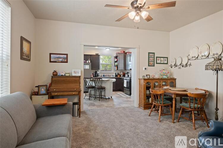 A living room with a grey couch and a wooden table.