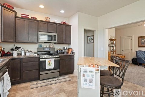 A kitchen with brown cabinets and a wooden island.