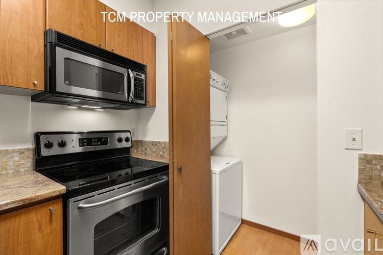 A kitchen with a stove, oven, microwave, and a dishwasher.