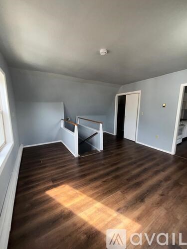 A room with wooden floors and white walls.
