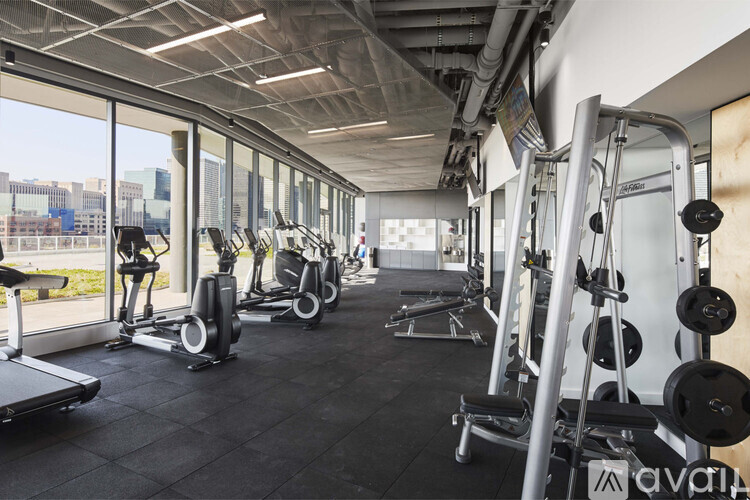 A gym with treadmills, weights, and exercise machines.
