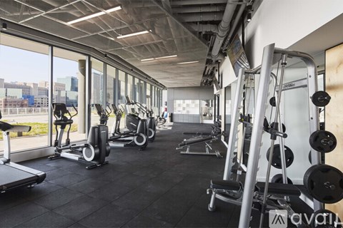 A gym with treadmills, weights, and exercise machines.