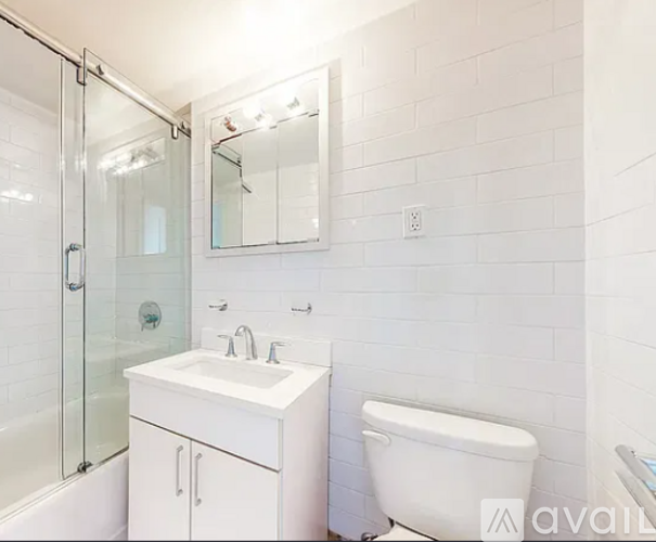 A white bathroom with a sink, toilet, and bathtub.