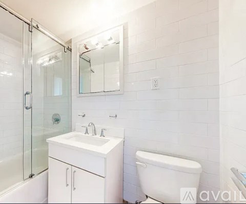 A white bathroom with a sink, toilet, and bathtub.