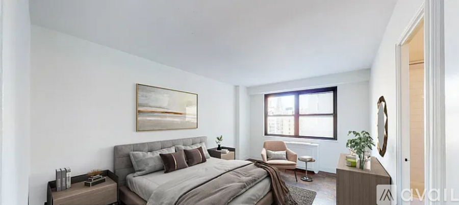 A bedroom with a large bed and a chair.